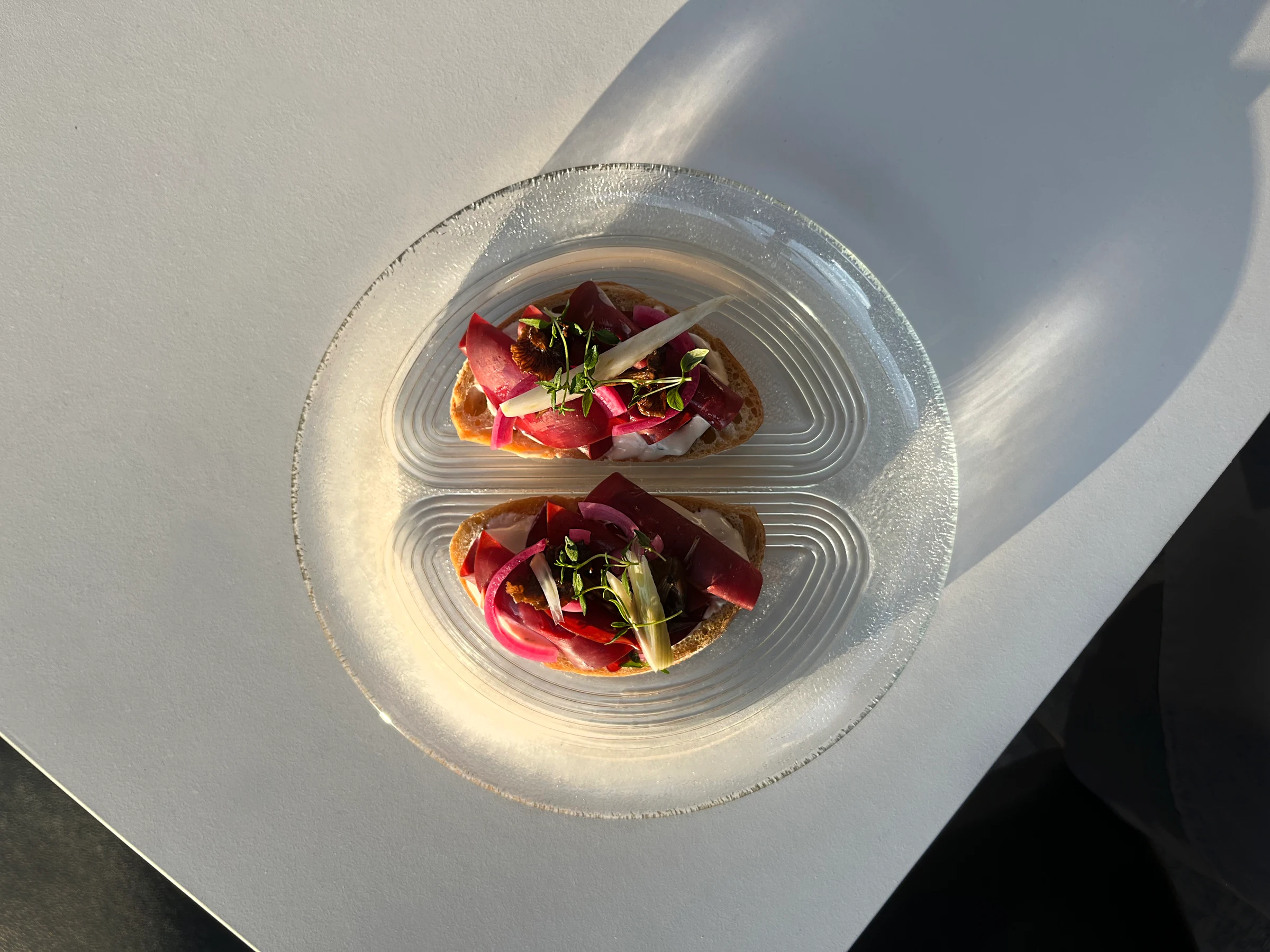 Nöösi open sandwiches on a glass plate in the sunlight